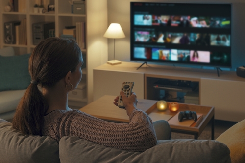 Woman,Relaxing,On,The,Couch,,She,Is,Using,The,Remote digital-media-buying-vermont
